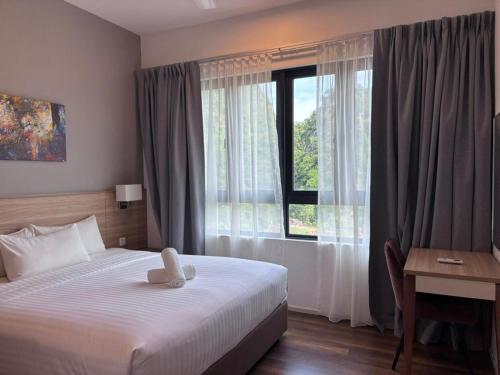 a bedroom with a bed with a teddy bear on it at Theme Park Ipoh - Onsen Premier Suites By MICASA GROUP in Ipoh