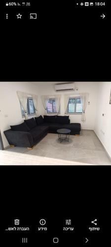 a living room with a couch and a table at הבית של רביבו in Sderot