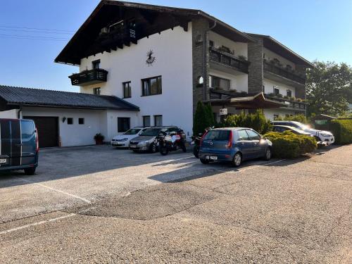 a building with cars parked in a parking lot at Keutschacherhof in Keutschach am See