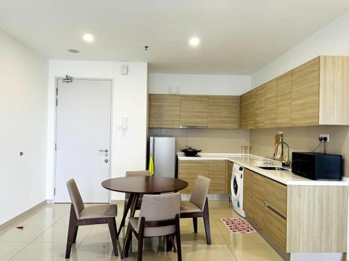 a kitchen with a table and chairs in a kitchen at Novel Homes at i-City - WiFi TV Box 1 Carpark in Shah Alam