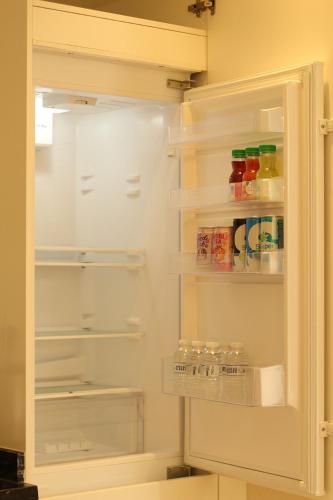 a white refrigerator with its door open with drinks at WeTake Hawana in Salalah