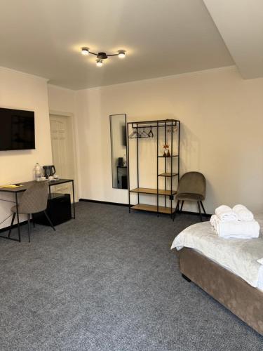 a bedroom with a bed and a desk and a table at Aero Hotel in Chişinău