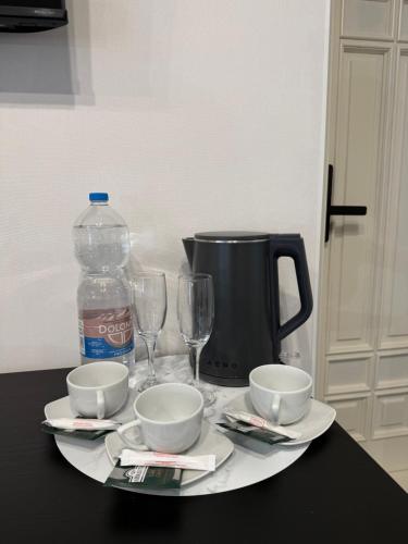 a table with two glasses and a bottle of water at Aero Hotel in Chişinău