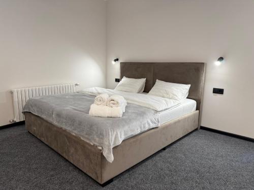 a bedroom with a large bed with towels on it at Aero Hotel in Chişinău