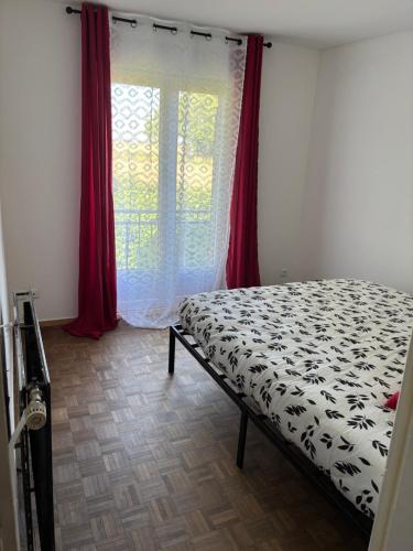 a bedroom with a bed in front of a window at G&J fourmidables in Récourt