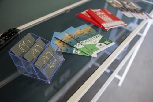 a glass table with pamphlets and books on it at Maison Le Blanc Luxury B&B in Giovinazzo