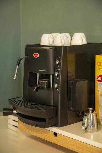 a black coffee maker sitting on top of a counter at Maison Le Blanc Luxury B&B in Giovinazzo