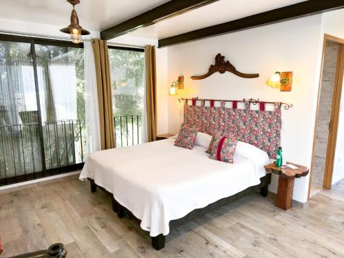 a bedroom with a bed and a large window at AYCA La Flora Hotel Boutique in Valparaíso