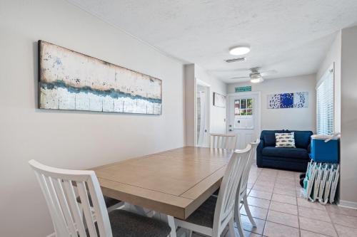 a dining room with a wooden table and chairs at Bianco Sands By Beachside Management in Siesta Key