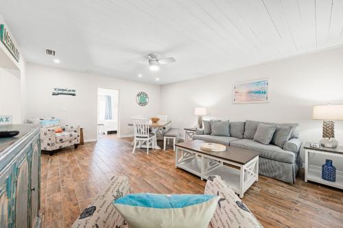a living room with a couch and a table at Bianco Sands By Beachside Management in Siesta Key