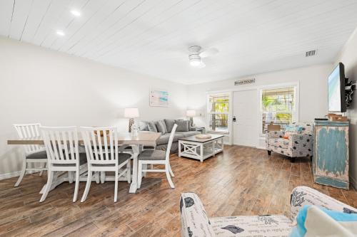 a dining room and living room with a table and chairs at Bianco Sands By Beachside Management in Siesta Key