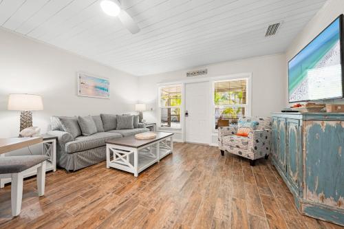a living room with a couch and a table at Bianco Sands By Beachside Management in Siesta Key