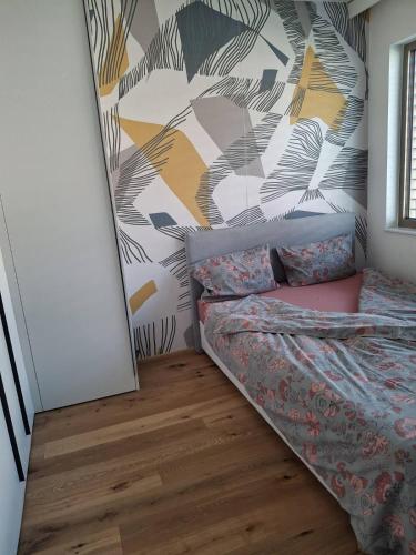 a bedroom with a bed and a wall at 3 Zimmer Wohnung in Maria Lanzendorf