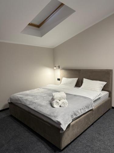 a bedroom with a bed with two towels on it at Aero Hotel in Chişinău