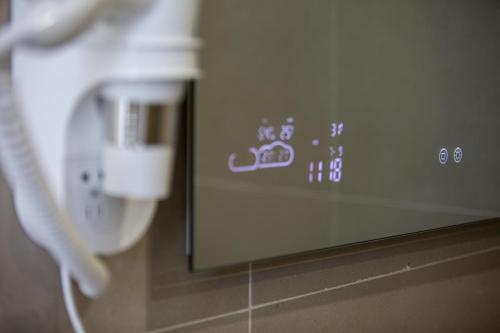 a close up of a white phone in a room at Maison Le Blanc Luxury B&B in Giovinazzo