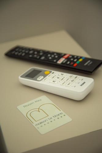 two remote controls sitting on top of a table at Maison Le Blanc Luxury B&B in Giovinazzo