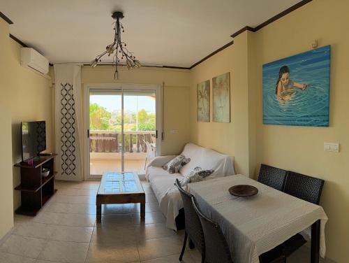 a living room with a couch and a table at Bolnuevo Apartment in Bolnuevo