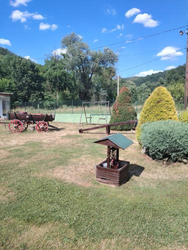 a park with a playground with a bench and a table at Apartmani Mihajlovic Sisevac in Sisevac