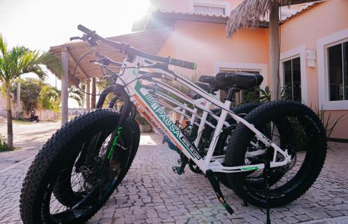 a bike is parked on a brick street at PAUSA Hotel in Fortim