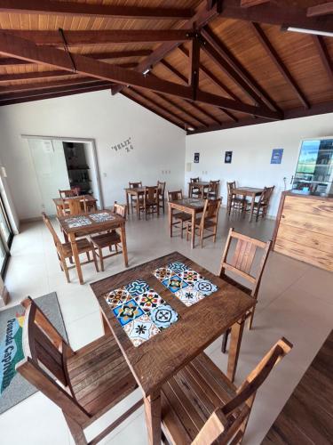 a dining room with wooden tables and chairs at Pousada Capitólio in Capitólio