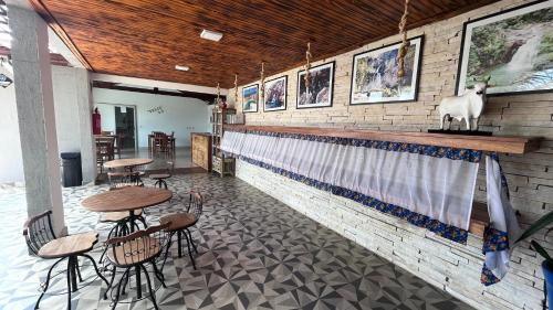 a restaurant with a bar with a goat on the wall at Pousada Capitólio in Capitólio