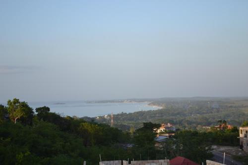 a view of a body of water from a hill at Negril Sky Blue Resorts LTD in Negril