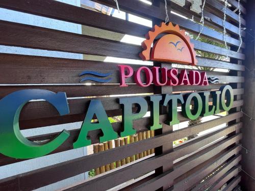 a sign for a pomegranada super store at Pousada Capitólio in Capitólio