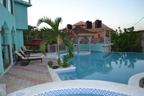 a swimming pool in the backyard of a house at Negril Sky Blue Resorts LTD in Negril