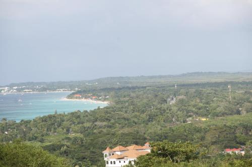 a view of the ocean and a house at Negril Sky Blue Resorts LTD in Negril
