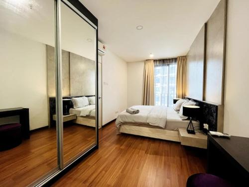 a bedroom with a bed and a large mirror at Onyx Homes at i-City - WiFi TV Box and 1 Car Park in Shah Alam
