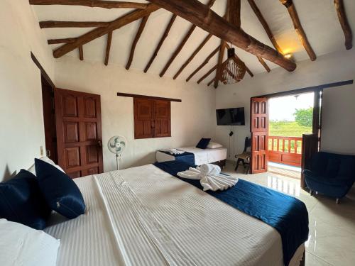 a bedroom with a large bed in a room at Hotel Palais Barichara in Barichara