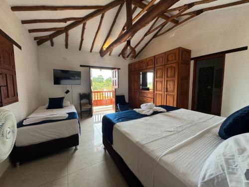 a bedroom with two beds in a room at Hotel Palais Barichara in Barichara