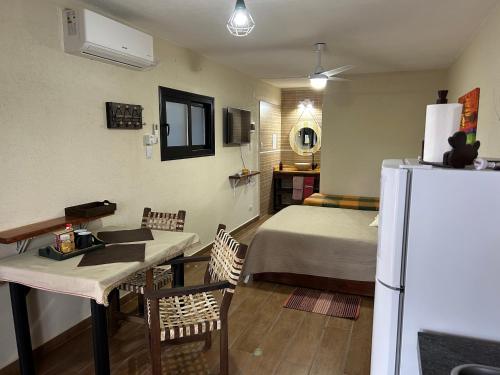 a small room with a bed and a refrigerator at Departamento mono ambiente vista a las Sierras in Villa Giardino