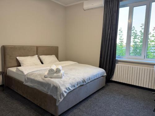 a bedroom with a bed with two towels on it at Aero Hotel in Chişinău