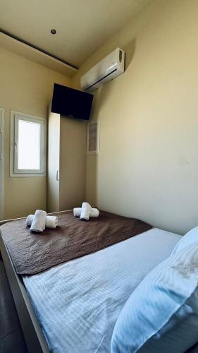 a bedroom with a large bed with two towels on it at Kotronia Suites in Skiathos Town