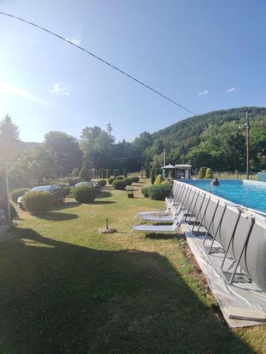 a row of chairs next to a swimming pool at Apartmani Mihajlovic Sisevac in Sisevac