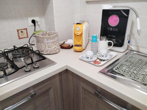a kitchen counter with a stove and a sink at Casa Mari in Ancona