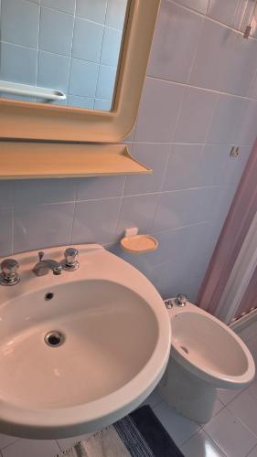a bathroom with a sink and a toilet at PM 20 Via Paolo Dettori in Badesi