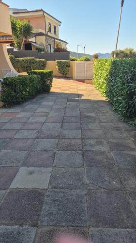 a stone walkway in front of a house at PM 20 Via Paolo Dettori in Badesi