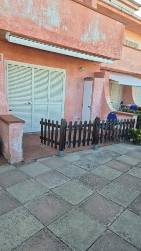 a wooden fence in front of a building at PM 20 Via Paolo Dettori in Badesi