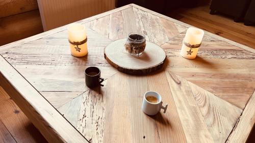 a coffee table with candles and cups on it at Datcha du Cap Fréhel in Plévenon