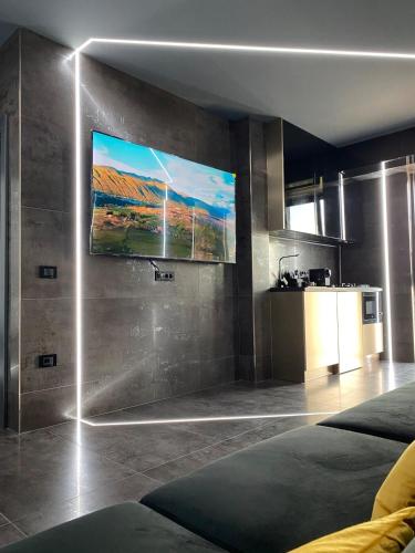 a living room with a television on the wall at Luna Apartments C in Suceava