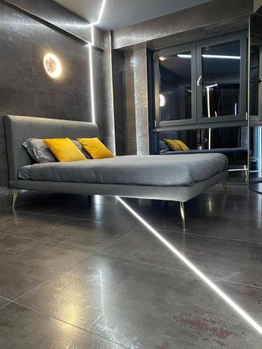 a bed in a room with yellow pillows on it at Luna Apartments C in Suceava