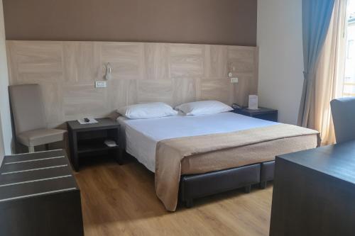 a bedroom with a bed and two nightstands and a bed sidx sidx sidx at Hotel Lory My Wellness SPA in Chianciano Terme