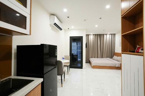 a kitchen with a living room and a bedroom at CĂN HỘ VINHOMES GRAND PARK QUẬN 9 Studio in Gò Công
