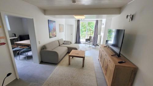 a living room with a couch and a flat screen tv at Urlauber und Monteure willkommen in Baesweiler