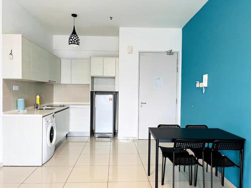 a kitchen with a table and chairs and a refrigerator at Skyline Homes at i-City - WiFi TV Box 1 Carpark in Shah Alam