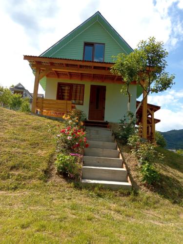 a house on a hill with stairs in front of it at Садиба Кичера in Petrashani