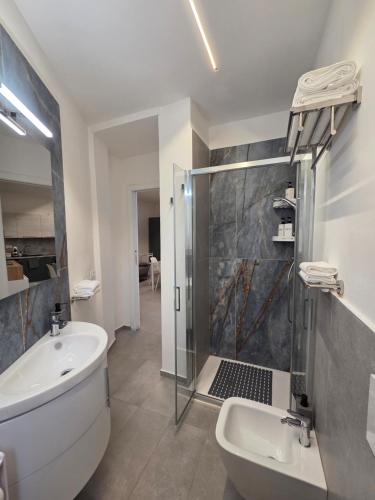 a bathroom with a shower and a toilet and a sink at Appartamento Teodorico Ravenna in Ravenna