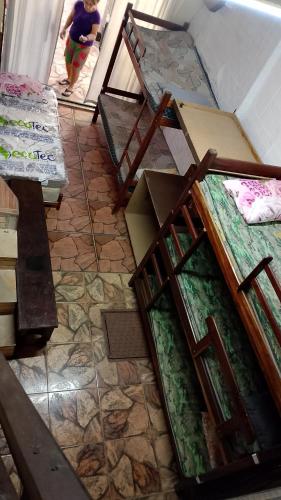 a room with boxes on the floor with a child walking in the doorway at Pousada Angelical in Saquarema